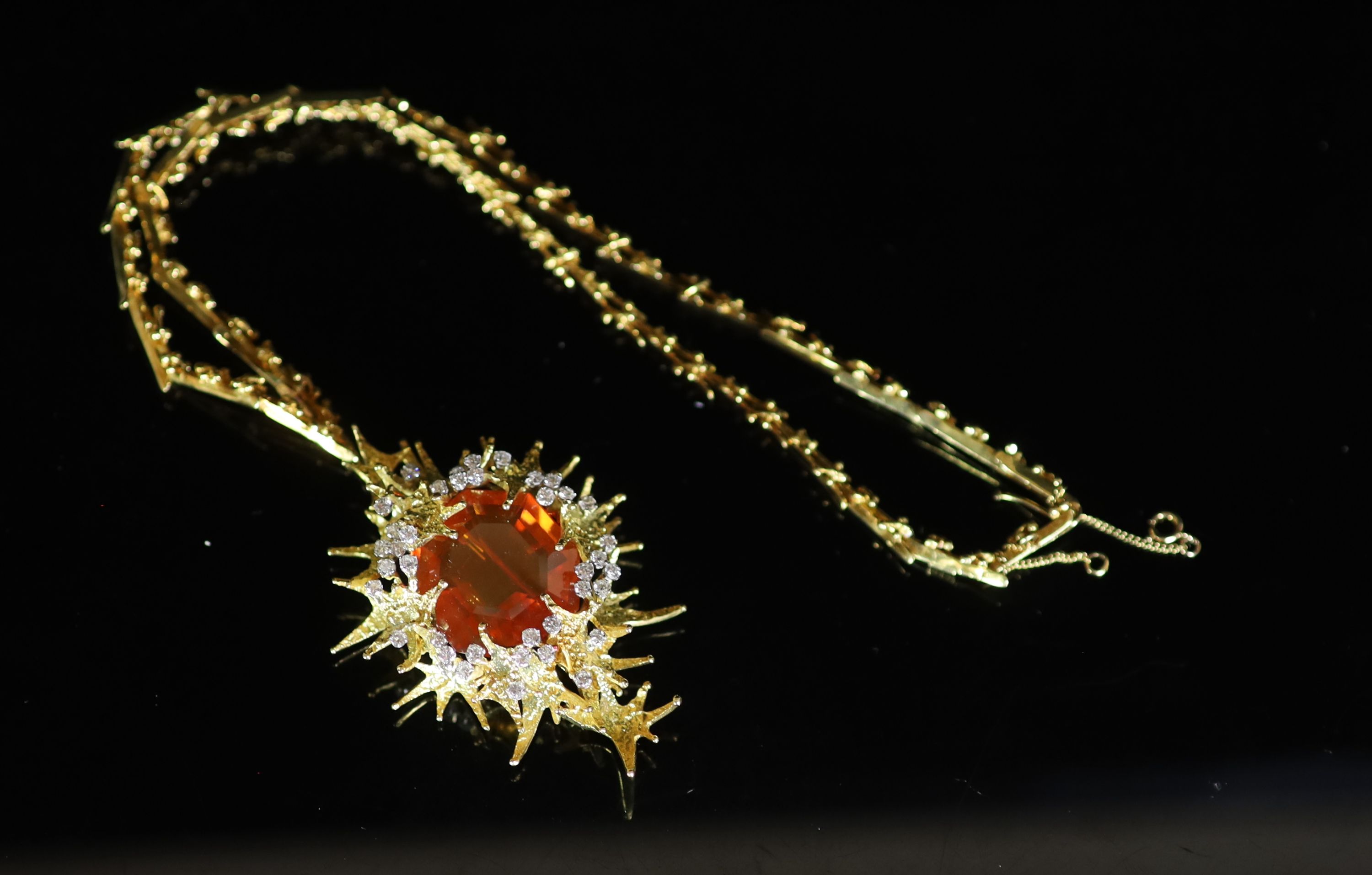 A stylish 1970's George Weil 18ct gold, platinum, fire opal and diamond set shaped oval pendant clip brooch, on an 18ct gold chain